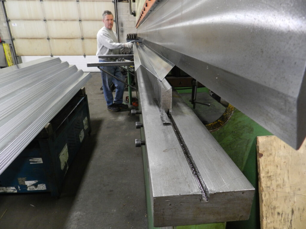 Sheet metal bending operation forming stamped brackets in production