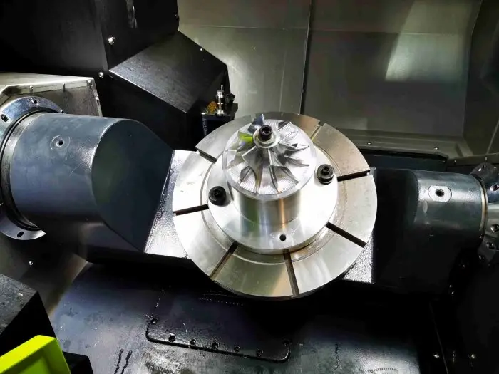 Engineer analyzing burr and crack defects on stamped metal parts