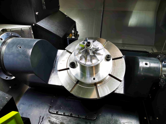Engineer analyzing burr and crack defects on stamped metal parts