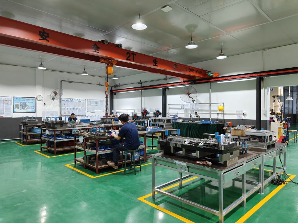 Custom metal stamping — progressive die producing precision sheet metal parts for OEM production