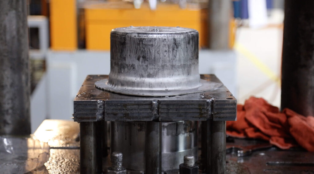 Deep draw stamping press forming cylindrical cup