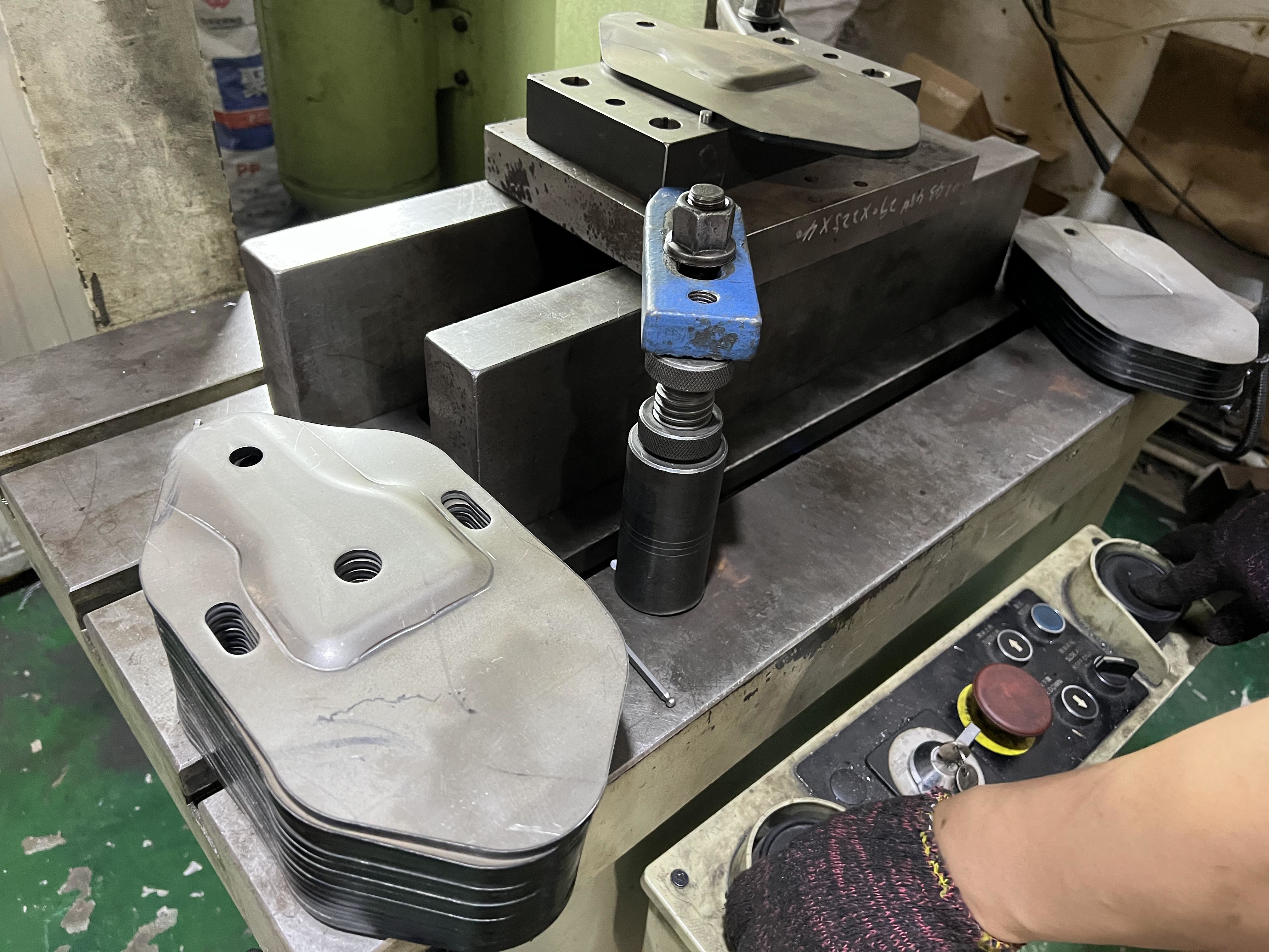 Progressive die strip showing multiple stamping stations for high volume production