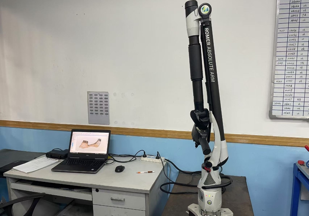 Quality inspection team at metal stamping manufacturer checking dimensional accuracy of parts