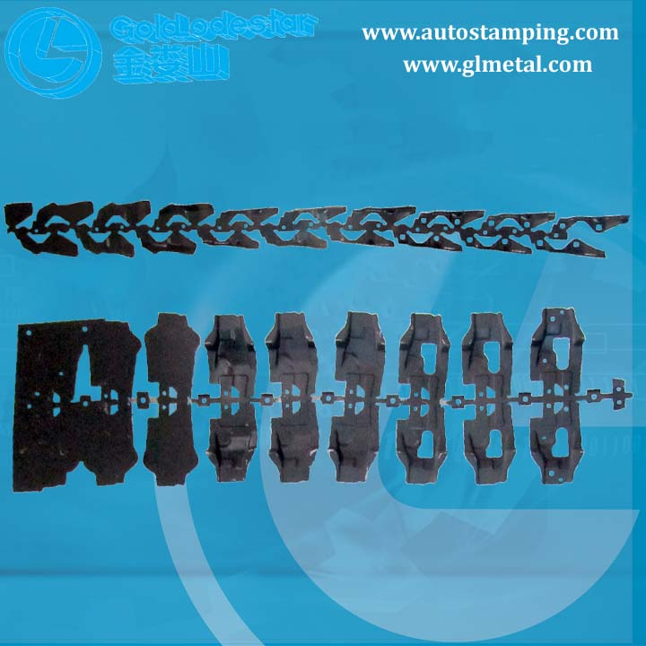 Progressive die stamping strip showing metal parts being formed in sequential stations