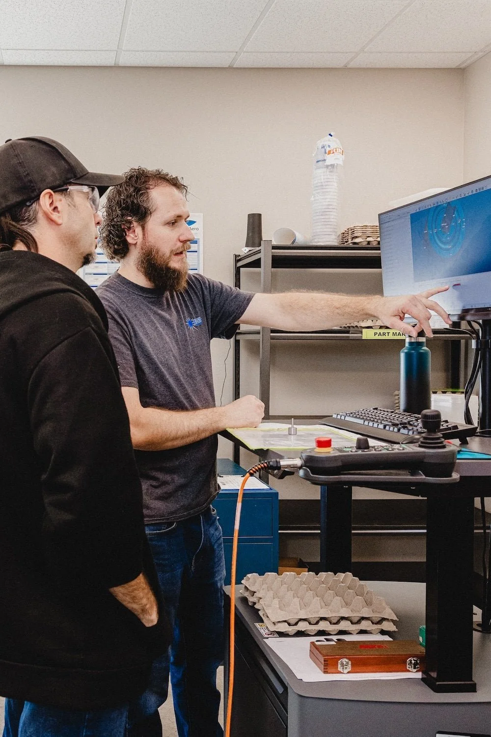 Engineer performing quality inspection on custom metal stamped parts using measurement tools
