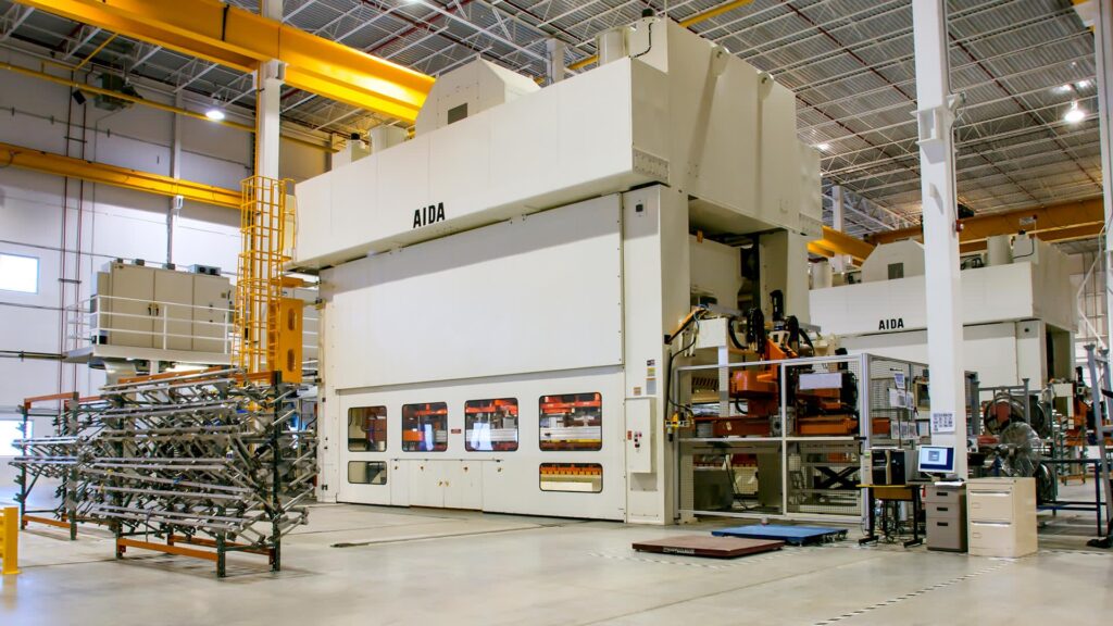 Transfer die stamping for large complex automotive parts with mechanical transfer fingers